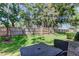 Backyard with a privacy fence and shady trees; a table and chairs are visible at 9814 Ashburn Lake Dr, Tampa, FL 33610