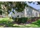 Scenic view of the backyard with manicured hedges and the building's exterior at 9814 Ashburn Lake Dr, Tampa, FL 33610