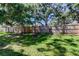 A private backyard with a wood fence and mature shade trees at 9814 Ashburn Lake Dr, Tampa, FL 33610