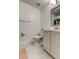 Well-lit bathroom with a modern vanity, tile floors, and a toilet with storage above at 9814 Ashburn Lake Dr, Tampa, FL 33610