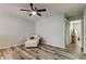 Bedroom with a ceiling fan, wooden floors, sofa, and lots of space at 9814 Ashburn Lake Dr, Tampa, FL 33610