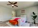 Bedroom with wooden style flooring, bright lighting, and an ensuite at 9814 Ashburn Lake Dr, Tampa, FL 33610
