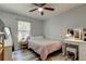 Bedroom with a ceiling fan, vanity with lighting, and wood-look flooring at 9814 Ashburn Lake Dr, Tampa, FL 33610