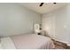 This bedroom has a ceiling fan, closet, vanity with lighting, and wood-look flooring at 9814 Ashburn Lake Dr, Tampa, FL 33610