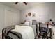 Inviting bedroom with a ceiling fan, closet, and a workspace with a desk and chair at 9814 Ashburn Lake Dr, Tampa, FL 33610