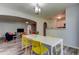 Open-concept dining area with modern lighting, dining table and view into the living room at 9814 Ashburn Lake Dr, Tampa, FL 33610