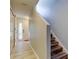 Hallway featuring tile floors, coat closet, front door, and stairs to the upper level at 9814 Ashburn Lake Dr, Tampa, FL 33610