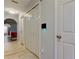 Hallway entrance with tile flooring and an arched opening into a living area at 9814 Ashburn Lake Dr, Tampa, FL 33610