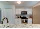 Modern kitchen featuring white cabinetry, stainless steel appliances, and granite countertops at 9814 Ashburn Lake Dr, Tampa, FL 33610