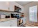 Bright kitchen with white cabinets, granite countertops and stainless appliances at 9814 Ashburn Lake Dr, Tampa, FL 33610