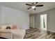 Spacious living room with a ceiling fan, wooden floors, and a couch at 9814 Ashburn Lake Dr, Tampa, FL 33610
