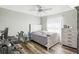 Cozy bedroom featuring wood floors, ceiling fan, a bed and a computer desk area at 10021 Elgin Blvd, Spring Hill, FL 34608