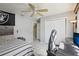 Bright bedroom with a ceiling fan, a closet, and a desk with computer, with gray walls and tile floors at 10021 Elgin Blvd, Spring Hill, FL 34608