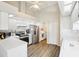 White kitchen features modern appliances, bright lighting, and convenient access to laundry room at 10021 Elgin Blvd, Spring Hill, FL 34608