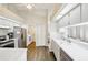 Functional kitchen featuring white cabinets, stainless steel appliances, and wood-look flooring at 10021 Elgin Blvd, Spring Hill, FL 34608