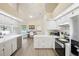 Well-lit kitchen offering ample counter space, modern appliances, and views of the pool area and home office at 10021 Elgin Blvd, Spring Hill, FL 34608