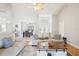 Spacious living room with open layout, cozy seating, and a view into the dining area at 10021 Elgin Blvd, Spring Hill, FL 34608