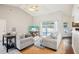 Bright living room featuring vaulted ceilings, comfortable seating, and sliding glass doors to the pool area at 10021 Elgin Blvd, Spring Hill, FL 34608