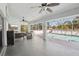 Covered outdoor patio space perfect for entertaining, with multiple ceiling fans and views of the pool at 10021 Elgin Blvd, Spring Hill, FL 34608