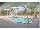 Screened-in pool offering a relaxing space with clear water and an outdoor chair for lounging at 10021 Elgin Blvd, Spring Hill, FL 34608