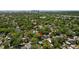 Aerial view of tree-lined neighborhood with cozy homes and the city skyline in the distance; the property location is marked at 1205 E Emma St, Tampa, FL 33603