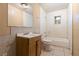 Bathroom featuring a large mirror, sink, toilet, and a tub/shower at 1205 E Emma St, Tampa, FL 33603