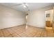A bedroom with a ceiling fan shows access to other rooms, featuring durable tile flooring at 1205 E Emma St, Tampa, FL 33603