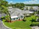 Aerial view showcasing the home's manicured lawn and well-maintained landscaping at 1211 Golfview Woods Dr, Sun City Center, FL 33573