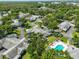 Aerial view of neighborhood highlighting community pool and lush green trees at 1211 Golfview Woods Dr, Sun City Center, FL 33573