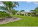 Spacious backyard boasting lush green grass, mature trees, and well-maintained landscaping at 1211 Golfview Woods Dr, Sun City Center, FL 33573