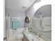 Well-lit bathroom featuring a modern vanity with granite countertops, a large mirror, and a glass-enclosed shower at 1211 Golfview Woods Dr, Sun City Center, FL 33573