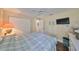 Bedroom featuring bright natural light, hardwood floors, a ceiling fan, and a large closet at 1211 Golfview Woods Dr, Sun City Center, FL 33573