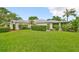Well-maintained single-story home with manicured lawn and lush landscaping at 1211 Golfview Woods Dr, Sun City Center, FL 33573
