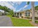 Charming single-story home with lush landscaping and large windows at 1211 Golfview Woods Dr, Sun City Center, FL 33573