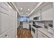 Efficient kitchen featuring white cabinets, modern appliances, granite counters and a stylish backsplash at 1211 Golfview Woods Dr, Sun City Center, FL 33573