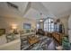 Bright living room boasts high ceilings, a ceiling fan, and a large window, creating an airy, welcoming space at 1211 Golfview Woods Dr, Sun City Center, FL 33573