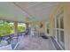 Relaxing covered patio with tile flooring, ceiling fan, and comfortable seating at 1211 Golfview Woods Dr, Sun City Center, FL 33573