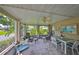 Relaxing screened patio featuring comfortable seating and a ceiling fan, perfect for enjoying the outdoors at 1211 Golfview Woods Dr, Sun City Center, FL 33573