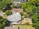 An aerial view of the home's roof and backyard with firepit, deck and fence at 1222 E Powhatan Ave, Tampa, FL 33604