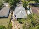 A high aerial view shows the home, backyard with firepit, and wooden deck at 1222 E Powhatan Ave, Tampa, FL 33604