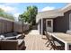 The wooden backyard deck is furnished with a table set and an outdoor sofa set at 1222 E Powhatan Ave, Tampa, FL 33604