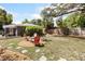 A fire pit in a mulch bed sits in the backyard of this home with chairs for outdoor relaxation at 1222 E Powhatan Ave, Tampa, FL 33604