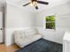 Well-lit bedroom featuring a futon, bright windows and a white dresser at 1222 E Powhatan Ave, Tampa, FL 33604
