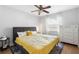 Cozy bedroom featuring a ceiling fan and bright window, complemented by a comfortable bed and dresser at 1222 E Powhatan Ave, Tampa, FL 33604