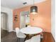 Dining area with a modern table and chairs next to a decorative shelf and view to an adjacent room at 1222 E Powhatan Ave, Tampa, FL 33604