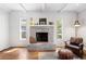 Charming living room with a brick fireplace, hardwood floors, and plenty of natural light at 1222 E Powhatan Ave, Tampa, FL 33604