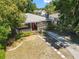 An aerial view of a single-story home with a red front door, gray siding, and a well-kept lawn at 1222 E Powhatan Ave, Tampa, FL 33604