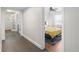 Hallway with tiled floors and view into a bedroom with plenty of natural light at 1222 E Powhatan Ave, Tampa, FL 33604