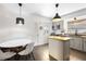 Bright kitchen featuring stainless steel appliances, granite countertops, and an island in an open layout at 1222 E Powhatan Ave, Tampa, FL 33604