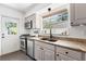 Cozy kitchen featuring stainless steel appliances, granite countertops, and a view of the backyard at 1222 E Powhatan Ave, Tampa, FL 33604